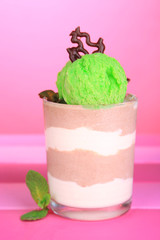 Tasty chocolate mousse with sorbet on pink background