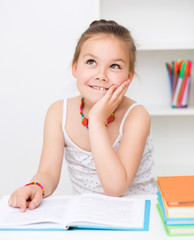 Cute girl is reading book