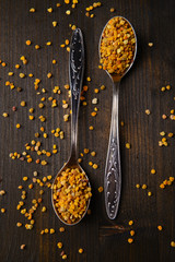 Spice  pollen in spoons on wooden background