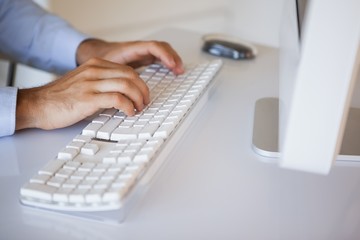 Businessman typing on keyboard at desk