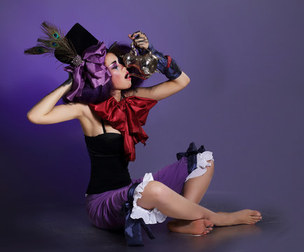 Stylized Harlequin in Fancy Cylinder Drinking from Jar