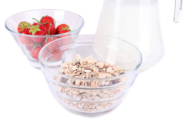 Healthy cereal in bowl with milk and strawberries isolated