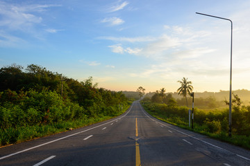 Fototapeta premium straight road and colorful sunset in thailand