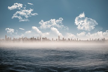 Cityscape on horizon over ocean - obrazy, fototapety, plakaty