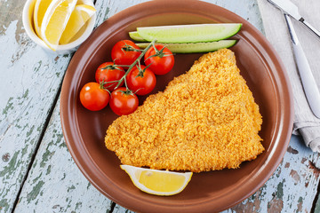 Breaded fish fillet with vegetables