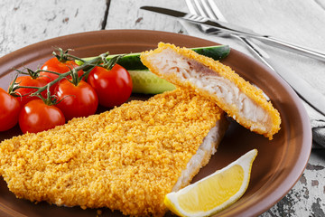 Breaded fish fillet with vegetables