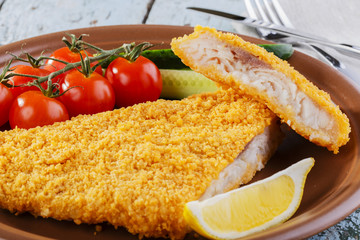Breaded fish fillet with vegetables