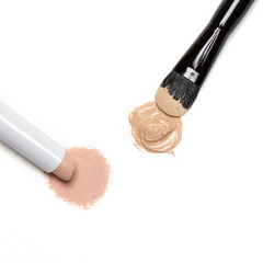 Concealer pencil and foundation with makeup brush