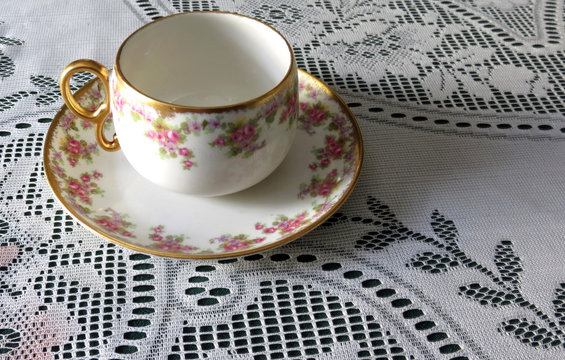 Limoges China Cup and Saucer on Lace Tablecloth