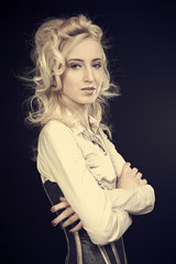 Naklejka premium Pretty blonde girl posing on black background
