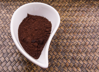 Ground coffee powder in ceramic container 