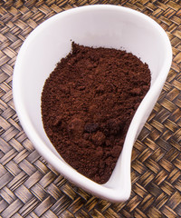 Ground coffee powder in ceramic container 