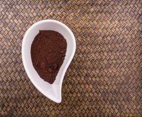 Ground coffee powder in ceramic container 