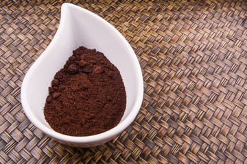 Ground coffee powder in ceramic container 
