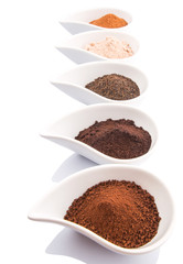 Cocoa powder, dried tea leaves and grounded coffee in ceramic