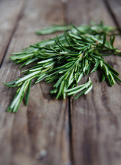 fresh rosemary bunch on an old rustic wooden table