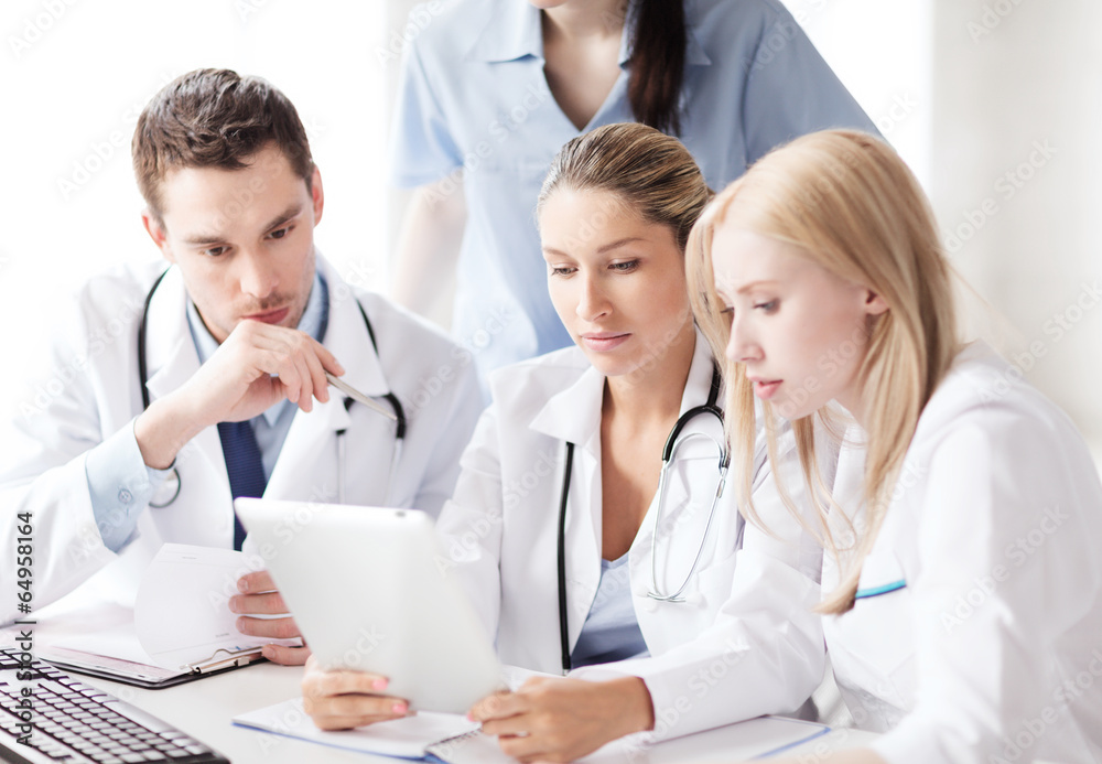 Poster group of doctors looking at tablet pc