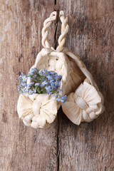 Russian decor: baby bast shoes with flowers forget-me-not