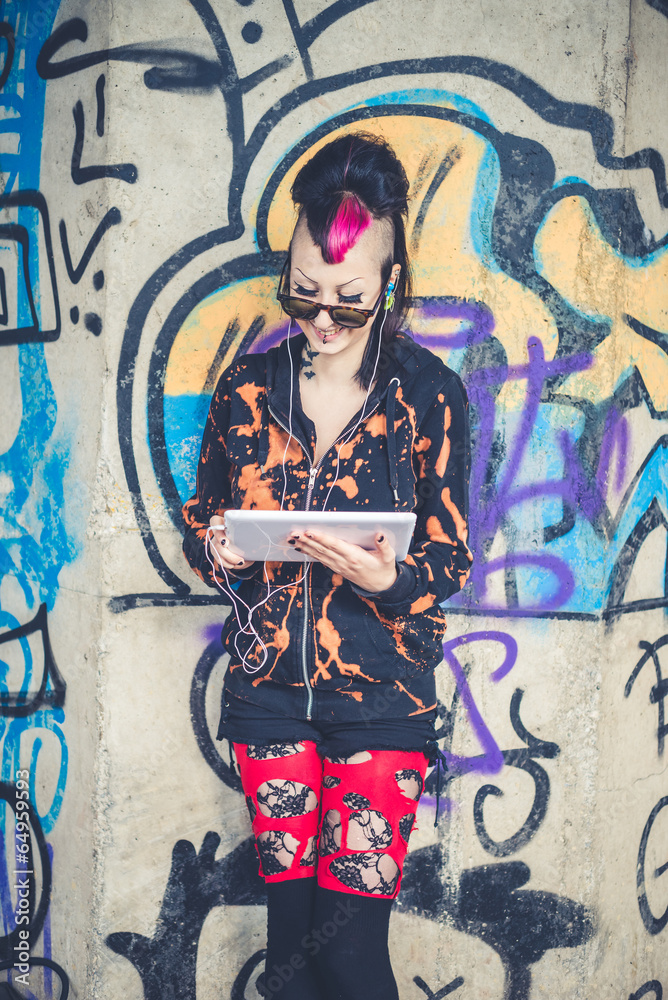 Wall mural young beautiful punk dark girl using tablet