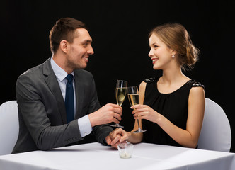 couple with glasses of champagne at restaurant