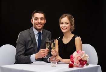 couple with glasses of champagne at restaurant