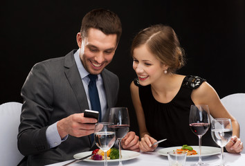 smiling couple eating main course at restaurant