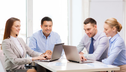 business team working with laptop in office
