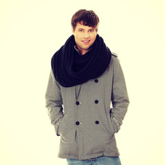 Handsome man in scarf and coat