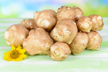 Topinambur roots on table on light background