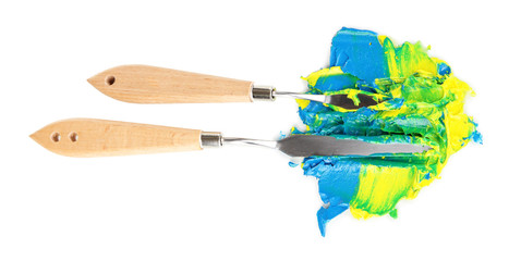 Painting palette knifes with paint isolated on white