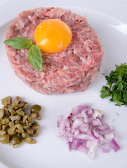 Delicious steak tartare with yolk on plate close-up