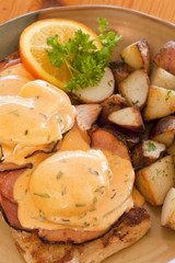 eggs benedict with ham and potatoes