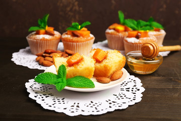 Tasty pumpkin muffins on wooden table
