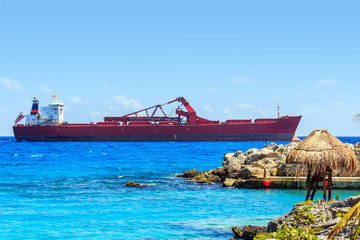 Lifeguard hut and huge container ship on Mexican coast