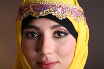 Beautiful muslim arabic woman on dark color background