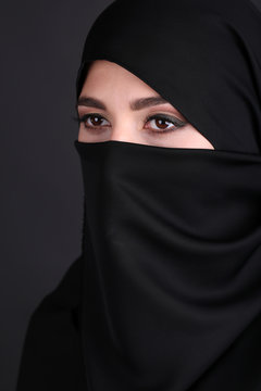 Beautiful muslim arabic woman in paranja on dark background