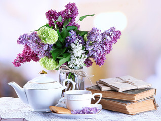Composition with teapot,  mug and beautiful spring flowers in