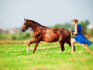 Fototapeta premium Running young beautiful girl with her horse