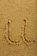 Alphabet letter written on wet beach sand
