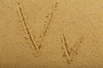 Alphabet letter written on wet beach sand