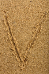 Alphabet letter written on wet beach sand