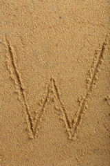 Alphabet letter written on wet beach sand