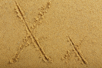 Alphabet letter written on wet beach sand