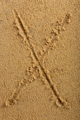 Alphabet letter written on wet beach sand