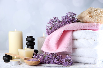 Fototapeta na wymiar Composition with spa treatment, towels and lilac flowers,