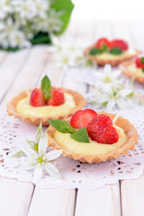 Tasty tartlets with strawberries on table close-up
