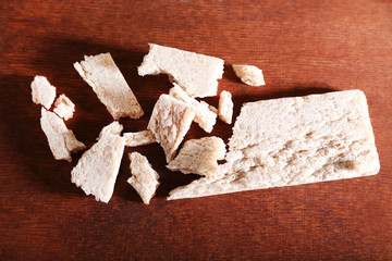 Crushed dietic rye bread on wooden background
