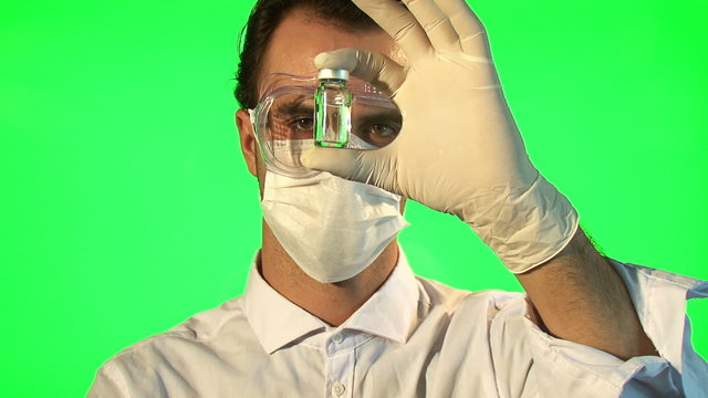 Scientist injecting blue liquid into bottle