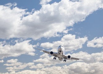 Fototapeta na wymiar Jet Airplane Landing with Dramatic Clouds Behind