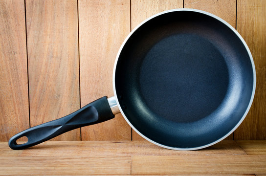 iron frying pan wooden background
